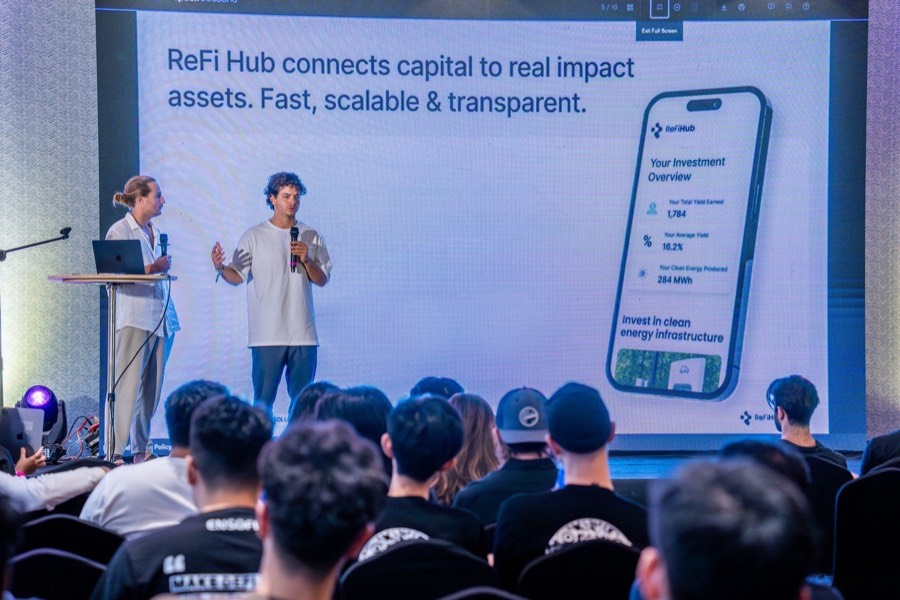 Two ReFi Hub team members presenting on stage at Solana Summit Vietnam 2025